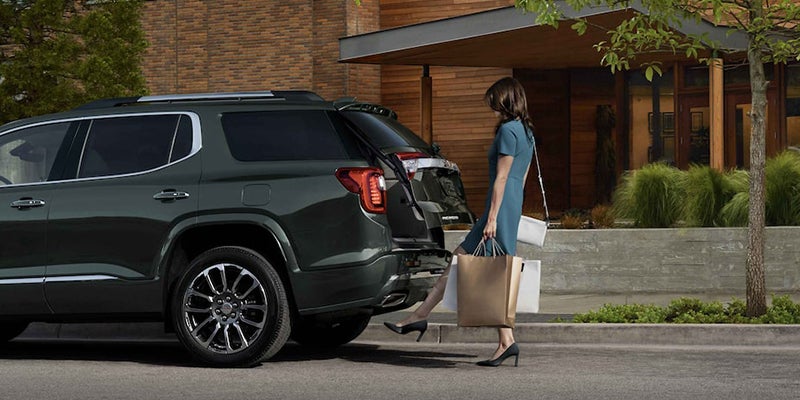 A women opens Rear door of White Corvette Car by leg sensor