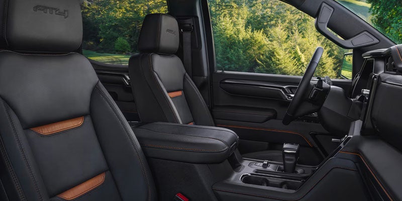 Interior of the 2026 GMC Sierra 1500 featuring premium front seats and center console